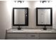 Modern bathroom featuring dual sinks with granite countertops, and sleek fixtures at 1359 Greenfield Loop, Kissimmee, FL 34747