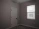 This cozy bedroom features neutral walls, plush carpeting, and a bright window with blinds at 1359 Greenfield Loop, Kissimmee, FL 34747