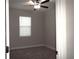 Bedroom featuring neutral walls, carpet, ceiling fan and a window, offering a comfortable space at 1359 Greenfield Loop, Kissimmee, FL 34747