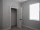Bedroom showcasing a closet with modern door, soft carpet, and natural light from the window at 1359 Greenfield Loop, Kissimmee, FL 34747