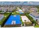 Aerial view of community amenities featuring a pool, basketball, and sand volleyball court at 1359 Greenfield Loop, Kissimmee, FL 34747