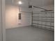 Spacious garage features a gray epoxy floor and white block walls, providing a clean, modern look at 1359 Greenfield Loop, Kissimmee, FL 34747