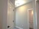 Hallway with neutral walls and view of bathroom at 1359 Greenfield Loop, Kissimmee, FL 34747