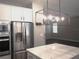 Modern kitchen featuring stainless steel appliances, white cabinets, and an island with countertop at 1359 Greenfield Loop, Kissimmee, FL 34747