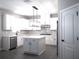 Bright kitchen with white cabinets, island, and stainless steel appliances at 1359 Greenfield Loop, Kissimmee, FL 34747