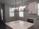 Modern kitchen island featuring quartz countertop and stylish lighting at 1359 Greenfield Loop, Kissimmee, FL 34747