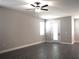 Bright living room featuring modern ceiling fan and wood-look flooring at 1359 Greenfield Loop, Kissimmee, FL 34747