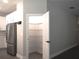 Pantry with wire shelving near kitchen and stainless refrigerator at 1359 Greenfield Loop, Kissimmee, FL 34747