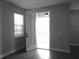 A bright patio visible from the interior through an open glass door and next to a large window at 1359 Greenfield Loop, Kissimmee, FL 34747