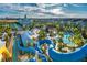 Aerial view of the community waterpark, featuring slides and a large resort pool at 1359 Greenfield Loop, Kissimmee, FL 34747