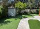 Grassy backyard with stone paver path and shed at 14419 Magnolia Ridge Loop, Winter Garden, FL 34787