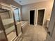 Bright bathroom featuring a glass shower, soaking tub, and tile floors at 14419 Magnolia Ridge Loop, Winter Garden, FL 34787