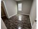 Comfortable bedroom with wood floors and a window offering natural light at 14419 Magnolia Ridge Loop, Winter Garden, FL 34787