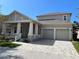 Charming two-story home with neutral paint, a two-car garage, and a brick paver driveway at 14419 Magnolia Ridge Loop, Winter Garden, FL 34787