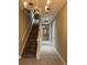 Hallway with staircase and view into living area at 14419 Magnolia Ridge Loop, Winter Garden, FL 34787