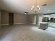 Open-concept living room and kitchen with tile floors, modern fixtures, and abundant space at 14419 Magnolia Ridge Loop, Winter Garden, FL 34787