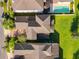 Aerial view of home exterior with back patio, lush green grass, and a private pool at 15129 Driftwood Bend St, Winter Garden, FL 34787