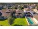Aerial view of home exterior with back patio, lush green grass, and a private pool at 15129 Driftwood Bend St, Winter Garden, FL 34787