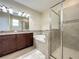 Bathroom features a glass enclosed shower, soaking tub, and vanity with a granite countertop at 15129 Driftwood Bend St, Winter Garden, FL 34787