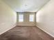 Spacious bedroom with neutral walls, carpet, and two windows with blinds at 15129 Driftwood Bend St, Winter Garden, FL 34787