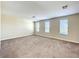 Large bedroom with neutral walls, carpet flooring, and multiple windows for natural light at 15129 Driftwood Bend St, Winter Garden, FL 34787