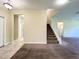 Open foyer with carpet and tile floors, staircase, and doorways, creating a seamless flow at 15129 Driftwood Bend St, Winter Garden, FL 34787