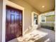 Inviting front entrance showcasing a stylish mahogany door and adjacent window with white shutters at 15129 Driftwood Bend St, Winter Garden, FL 34787