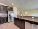 Well-equipped kitchen features stainless steel appliances, granite counters, and dark wood cabinets at 15129 Driftwood Bend St, Winter Garden, FL 34787