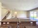 Open living room with staircase, neutral walls, carpet, and sliding glass doors to the outdoors at 15129 Driftwood Bend St, Winter Garden, FL 34787