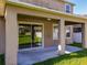 Covered patio features ceiling fan, natural lighting, and lush green grass at 15129 Driftwood Bend St, Winter Garden, FL 34787