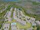 An aerial view of multi-Gathering homes with screened patios, parking, community pool and pond with views of conservation area at 1645 Retreat Cir, Clermont, FL 34714