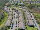 An aerial view of multi-Gathering homes with screened patios, a community pool, parking and bordering conservation area at 1645 Retreat Cir, Clermont, FL 34714