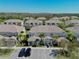 Overview of several townhomes in a well-planned community, featuring dedicated parking spots at 1645 Retreat Cir, Clermont, FL 34714
