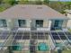 Rear aerial view of townhome showing balconies and screen-enclosed patios at 1645 Retreat Cir, Clermont, FL 34714