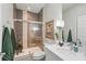 Modern bathroom with a glass shower enclosure, stylish vanity, and neutral tile at 1645 Retreat Cir, Clermont, FL 34714