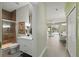 Stylish bathroom with a glass-enclosed shower and a vanity, leading to the dining area at 1645 Retreat Cir, Clermont, FL 34714