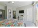 Bedroom with a sliding glass doors leading to a balcony and a view into the bathroom at 1645 Retreat Cir, Clermont, FL 34714