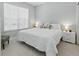 Serene bedroom featuring a large white bed, side tables, and a bright window at 1645 Retreat Cir, Clermont, FL 34714