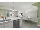 Open-concept kitchen with sleek counters, stainless appliances, flowing into a dining area with a view of the pool at 1645 Retreat Cir, Clermont, FL 34714