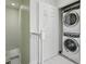 Laundry area with stacked washer and dryer, stairs and a storage closet at 1645 Retreat Cir, Clermont, FL 34714