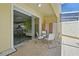 A view of the patio which includes a pool and furniture, plus a view inside the open sliding glass doors at 1645 Retreat Cir, Clermont, FL 34714