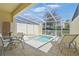 Screened-in patio featuring a private pool and a cozy seating area, perfect for relaxation at 1645 Retreat Cir, Clermont, FL 34714