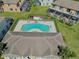 Community pool area with inviting blue water, sun loungers, and well-kept landscaping at 1645 Retreat Cir, Clermont, FL 34714