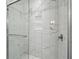 A close-up shot of a shower boasting floor-to-ceiling tile, a glass enclosure and a built-in niche at 1645 Retreat Cir, Clermont, FL 34714