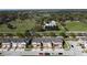 Aerial view of a residential neighborhood with tree-lined streets, green spaces, and well-maintained homes at 1737 Kato Way, Kissimmee, FL 34744
