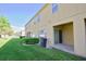 Spacious backyard area with a well-maintained lawn and a covered patio at 1737 Kato Way, Kissimmee, FL 34744