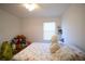 Cozy bedroom features a window and cheerful stuffed animals to create an inviting space at 1737 Kato Way, Kissimmee, FL 34744