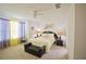 Well-lit bedroom features a neutral color palette, ceiling fan, and black furniture set at 1737 Kato Way, Kissimmee, FL 34744