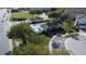 An aerial view showcases the community pool and clubhouse surrounded by lush landscaping and convenient parking at 1737 Kato Way, Kissimmee, FL 34744