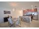 Bright kitchen and dining area with stainless steel appliances, granite counters, and island seating at 1737 Kato Way, Kissimmee, FL 34744